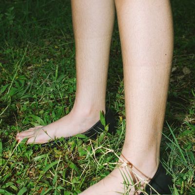 Close-up on a person's feet, firmly planted on the ground.